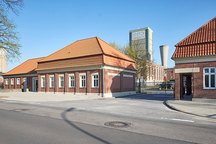 Die beiden Torhäuser bilden den Eingang zum Gelände der Zeche Westerholt. Dazwischen verläuft eine Straße, die durch ein Tor zwischen den Häusern führt.